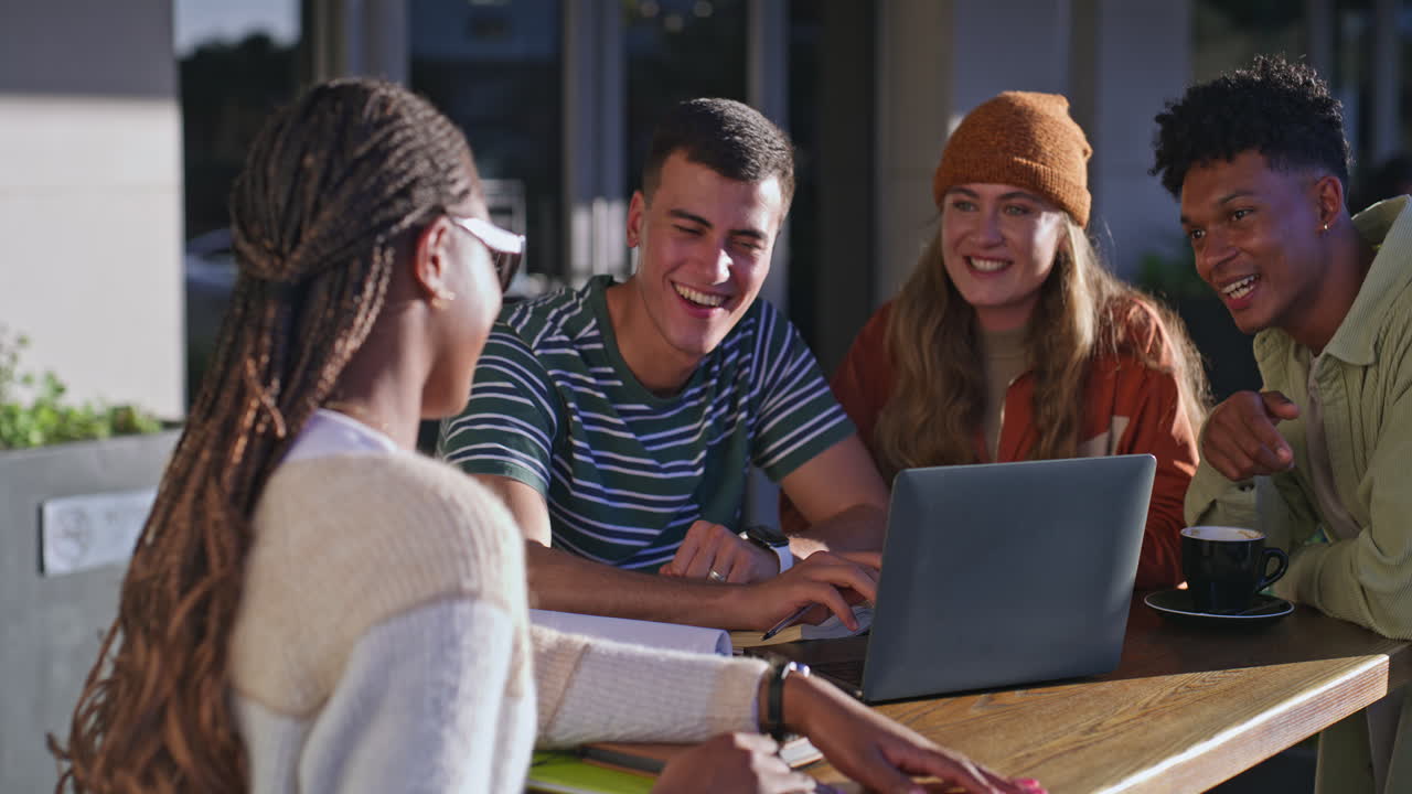 Group of students working together at outdoor cafe