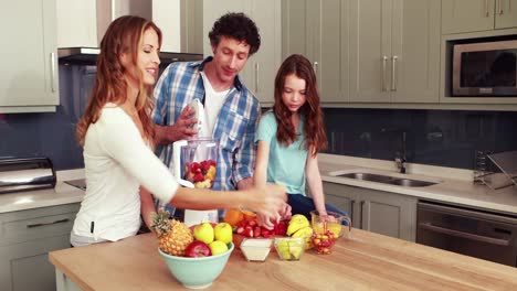 happy family making smoothie