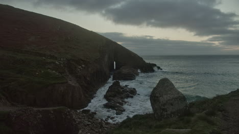 dramatic blue hour sunset over nanjizal beach and cove near land's end in cornwall, uk