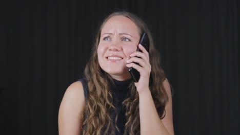 black background, worried woman having unpleasant phone call, slowmo