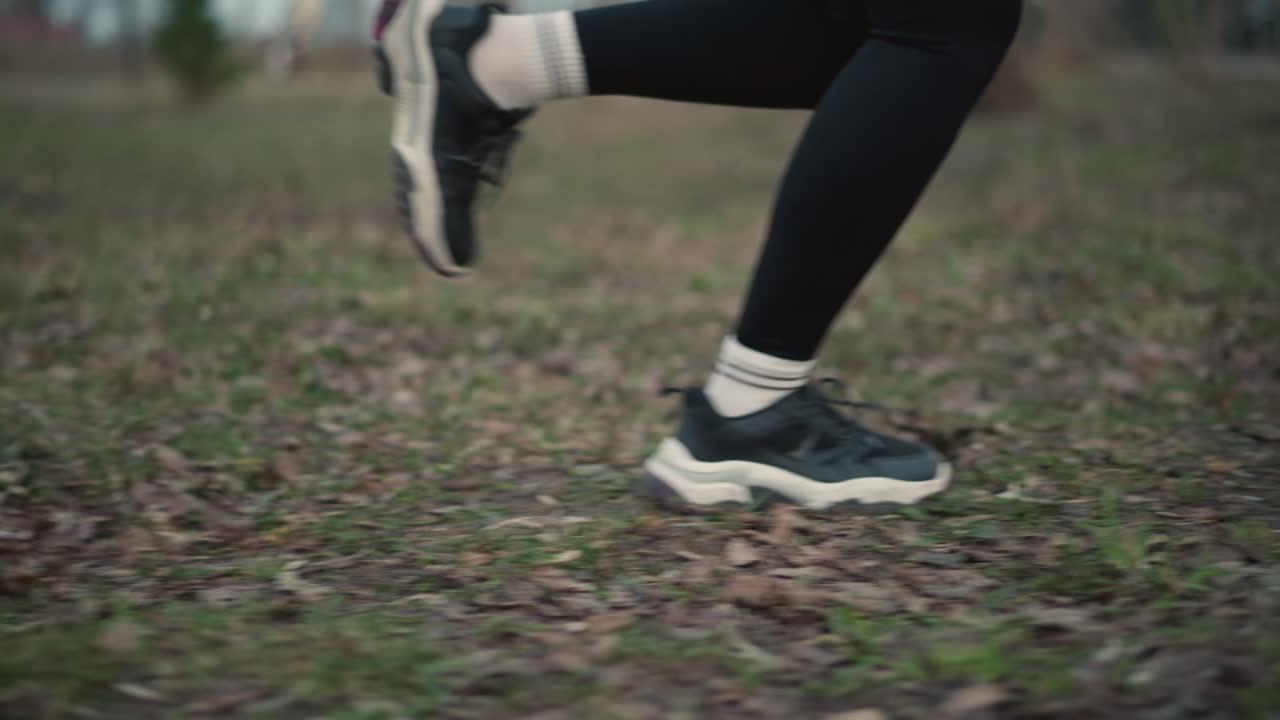 Sneaker Contact On Forest Path With Fallen Leaves, Athletic Shoe Hitting Leafcovered Ground During Trail Run, Close View Of Running Shoe Touching Trail Filled With Leaves During Exercise