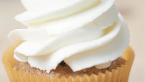 close-up of a decorated cupcake with whipped cream
