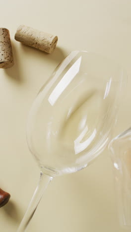 vertical video of white wine glasses on yellow surface