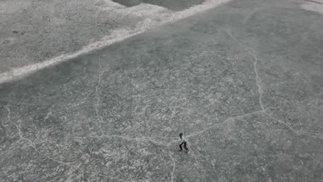 people ice skating past on frozen khalti lake at ghizer valley