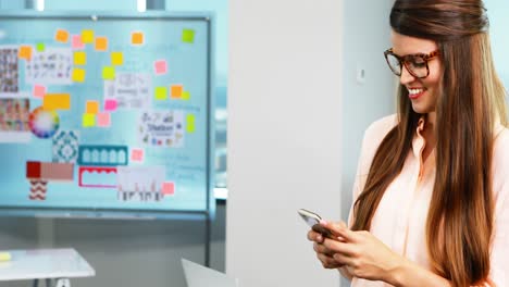 Ejecutiva-Femenina-Usando-Teléfono-Móvil-En-La-Oficina