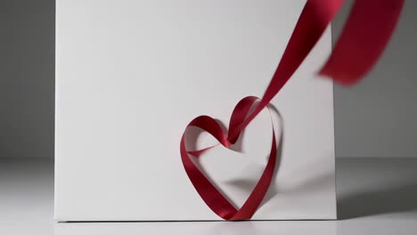 dynamic red ribbon art and design on white background