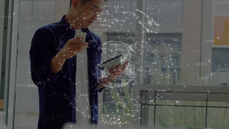 Animation of network of connections over asian businessman using smartphone and tablet