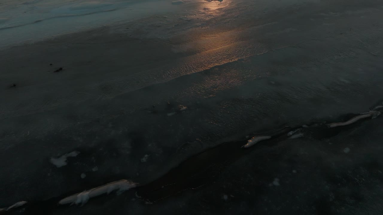 Low Flight Above Frozen Tidal Flats With Leafless Tree Woods At Sunset In Notsuke Peninsula, Hokkaido, Japan. drone tilt-up shot