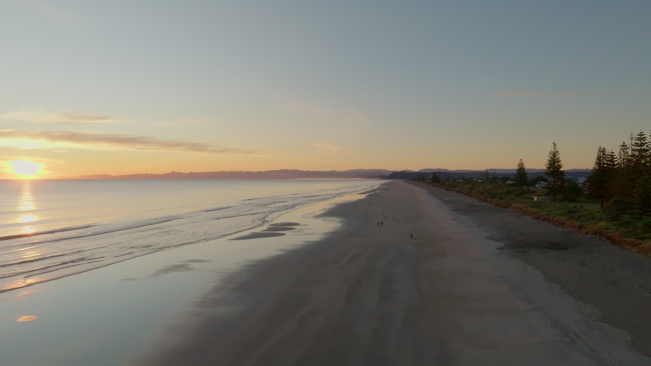 Rising over Ohope Beach at sunrise, Whakatane, New Zealand