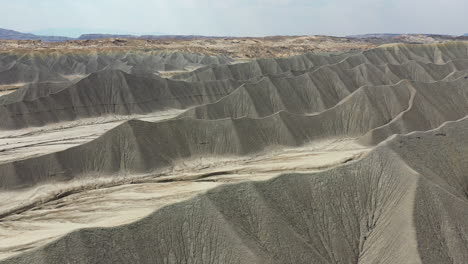 grey sandstone hills in utah desert usa, aerial view push pull dolly zoom effect