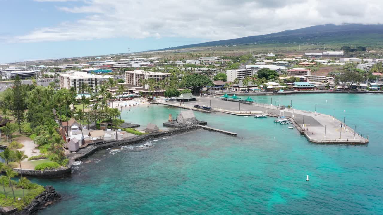 Aerial close-up dolly shot of the ancient Hawaiian cultural site Kamakahonu House, in Kailua-Kona on the Big Island of Hawai'i