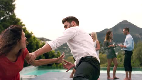 couple arguing poolside during garden party