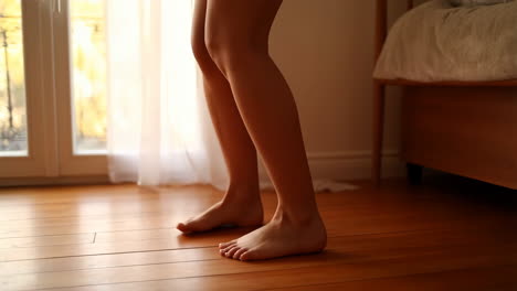 Legs and Feet in a Bright Bedroom