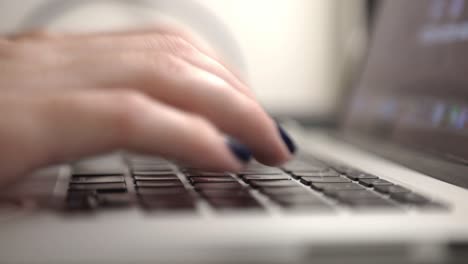 hands typing on a laptop keyboard