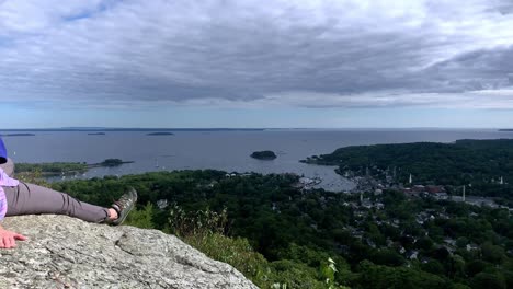 4k lady looks at camden maine from atop mount battie