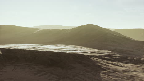 sunset over the sand dunes in the desert. aerial view