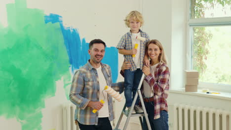 happy family painting the interior of their home