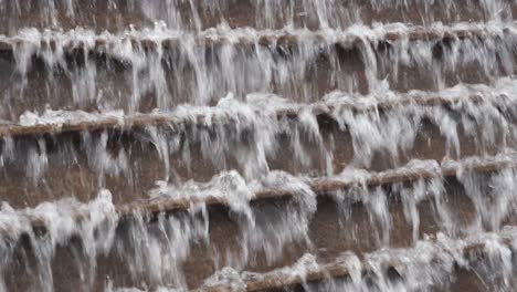 a decorative water small-size waterfall is seen at a garden in central district, hong kong.