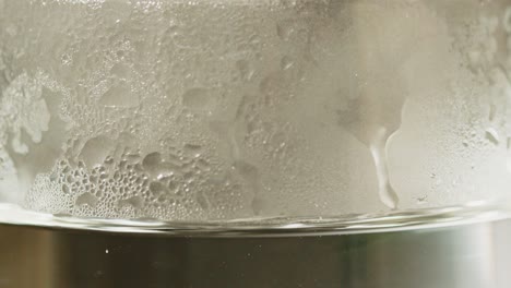 macro of fogged up glass filled with hot water