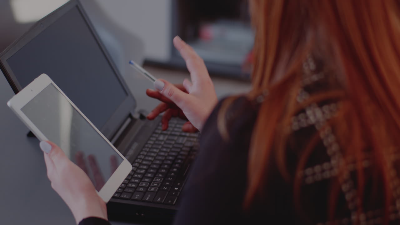 Woman working with laptop and tablet