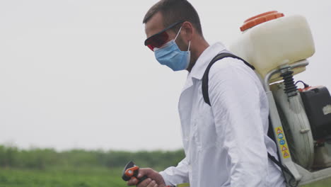 farmer spraying pesticides in a field