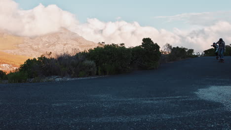 happy-multi-ethnic-friends-longboarding-together-cruising-downhill-on-beautiful-countryside-road-having-fun-skating-hanging-out-enjoying-relaxed-summer-vacation-slow-motion