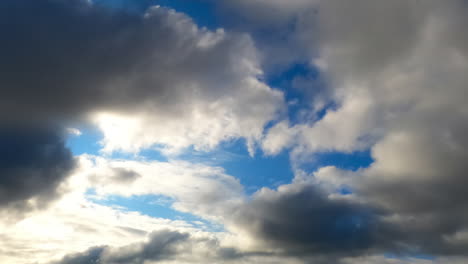 clouds shifting in timelapse. clouds move dynamically across the sky, showcasing varying formations and shades during a tranquil period