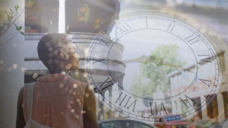 Animation-of-clock-over-african-american-woman-and-sea