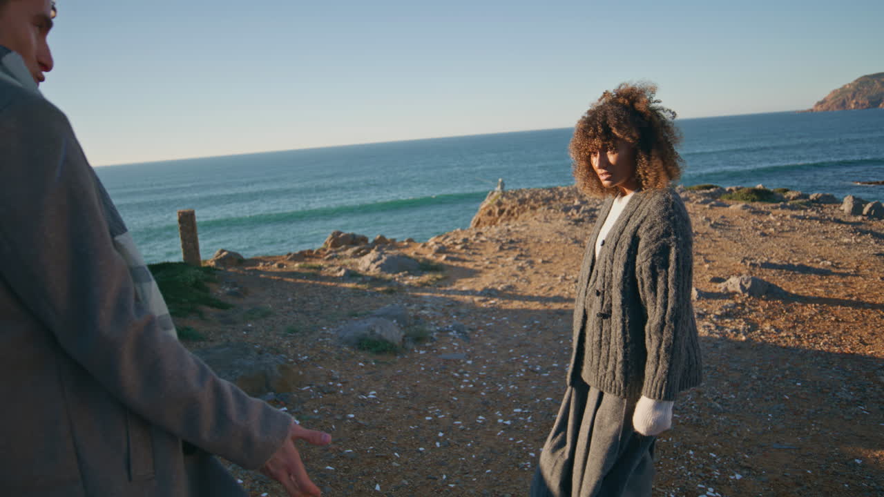Irritated girlfriend shouting boyfriend in seashore closeup. Couple arguing