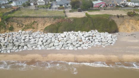 drone view of stones kept at shore of pakefield beach in lowestoft, england