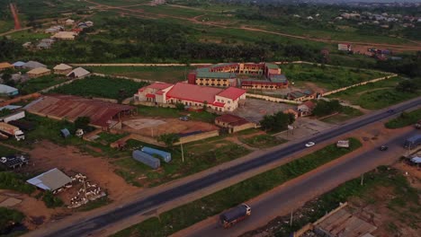 aerial of compounds and modern buildings alongside a busy road in nigeria, africa