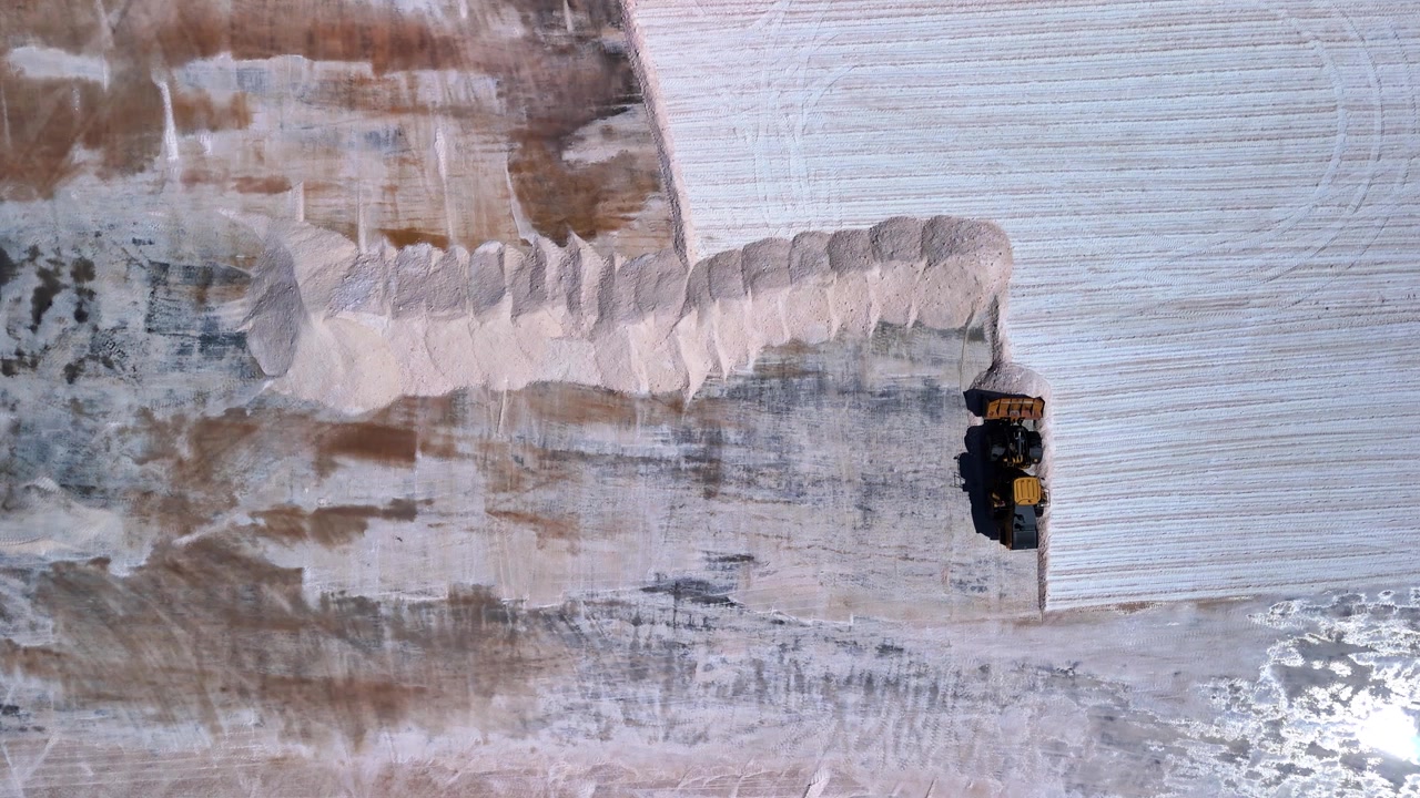 Top-Down Aerial of Loader moving salt at Walvis Bay Salt Works, Namibia