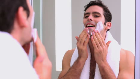 handsome man applying shaving foam