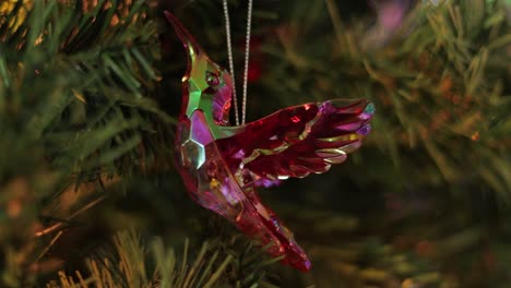 glittering iridescent crystal hummingbird decoration on christmas tree