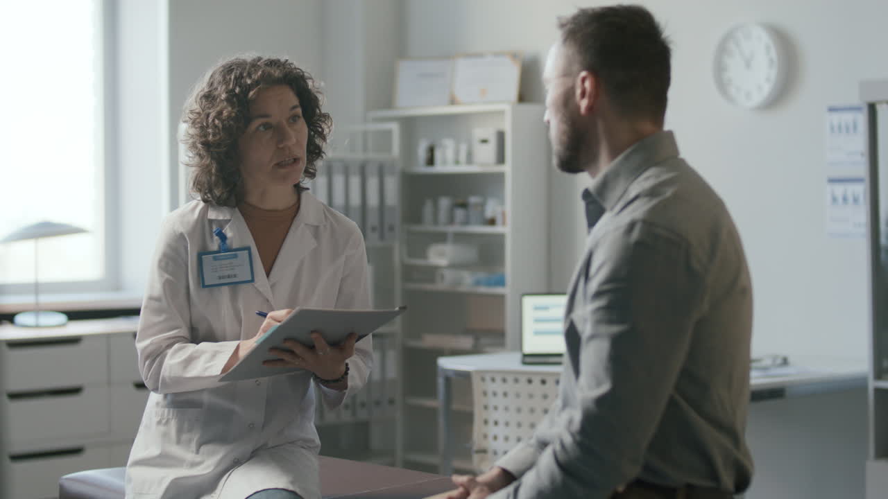 Female Doctor Asking Patient Questions during Medical Appointment