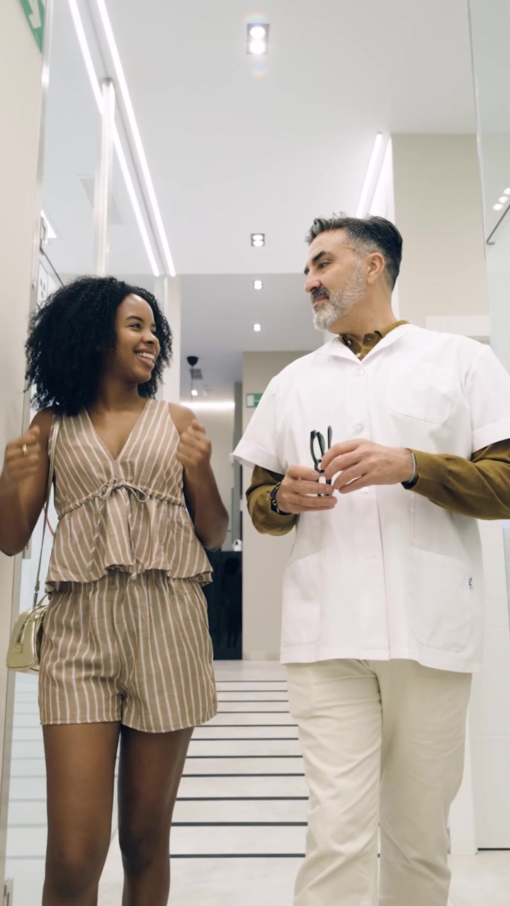 Doctor and Patient Walking and Talking in Modern Clinic Hallway