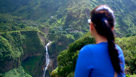 woman from behind in blue sweater looking at devil's caudron waterfall