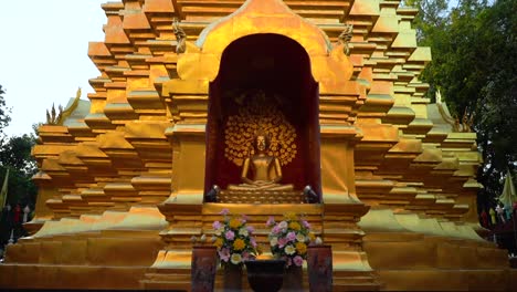 gliding in a golden buddha statue at a buddhist temple in chiang mai, thailand