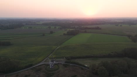 aerial view of dutch countryside with windmill at sunset