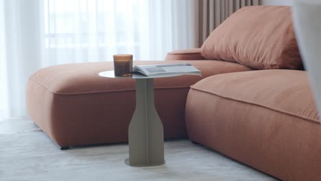 modern living room with orange sofa and gray coffee table