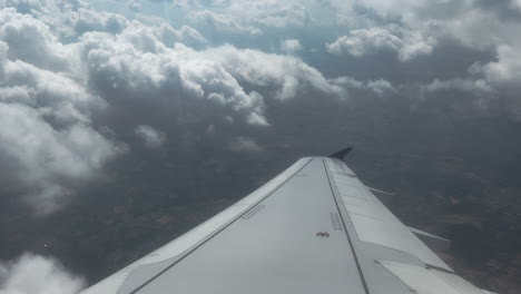 airplane wing with cloudscape view