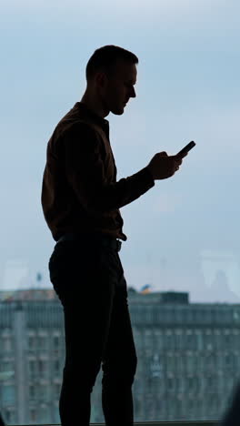 young businessman using smartphone in office vertical video