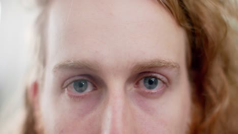 portrait close up of blue eyes of caucasian man with red hair, slow motion