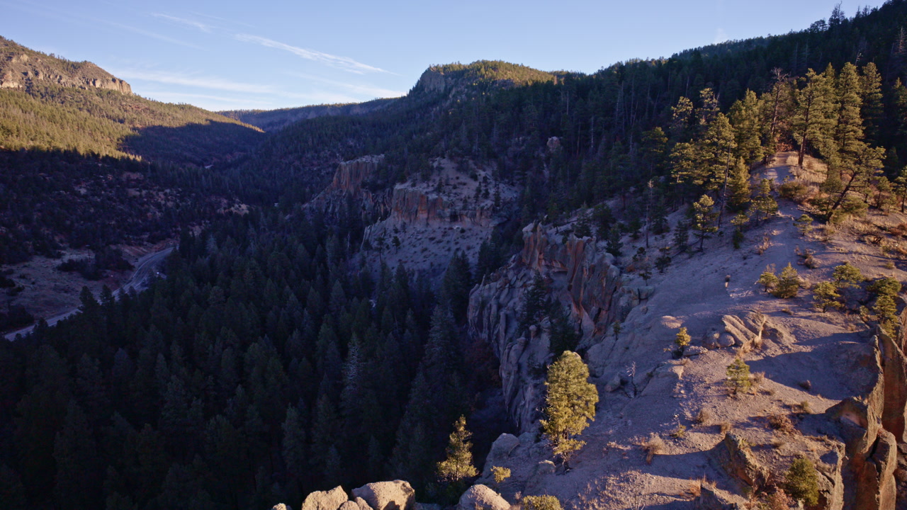 Drone flyover of steep rocky terrain and canyon formations near Los Alamos