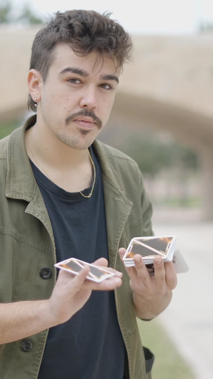 Young Man Performing a Card Magic Trick