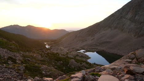 cinematic first light longs peak 14er sunrise rocky mountain national park above treeline colorado towards denver boulder estes park erie sunny late summer green dramatic landscape pan slowly left