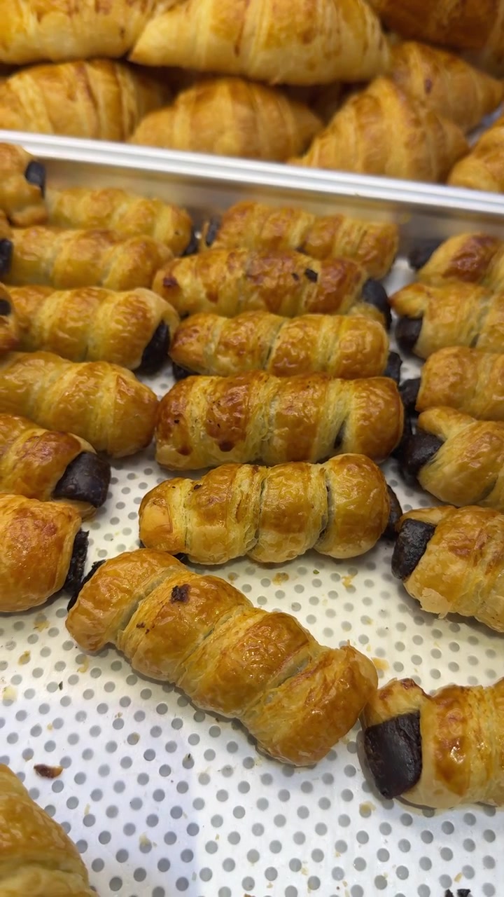 Freshly Baked Chocolate Pastry Rolls on a Bakery Tray