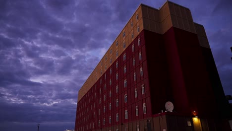 Apartment-building-against-cloudy-sky-at-sunset