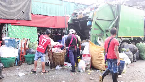 people gathering and disposing of waste at a market