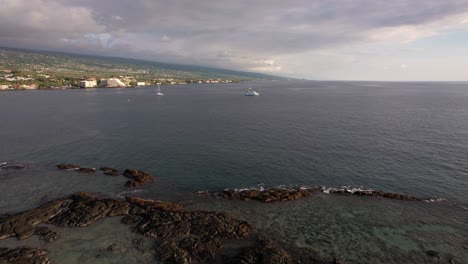 Skimming-over-Palm-Trees-and-tide-pools-on-Big-Island,-Hawaii---Hilo